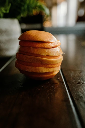 a stack of oranges sitting on top of a wooden table, crispy buns, handcrafted, 6 pack, wet clay