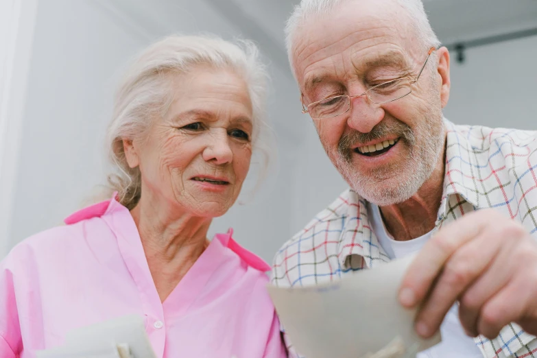 a man and a woman looking at a piece of paper, pexels contest winner, photorealism, nursing home, holding a bucket of kfc, smiling slightly, soup