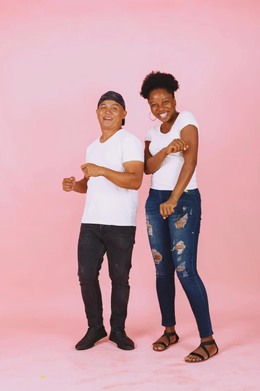 two people standing next to each other on a pink background, happening, jeans and t shirt, light skin tone, t pose, mixed race