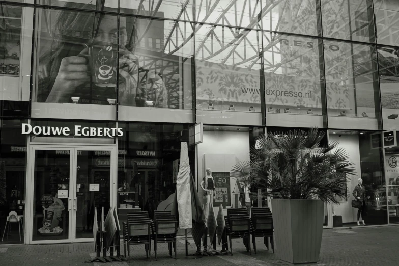 a black and white photo of a store front, inspired by Albert Paris Gütersloh, pexels, hyperrealism, food court in a mall, “erebos’s titan, eats bambus, embrace the superego