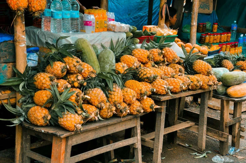 a bunch of pineapples sitting on top of a wooden table, unsplash, with street food stalls, avatar image, laos, square