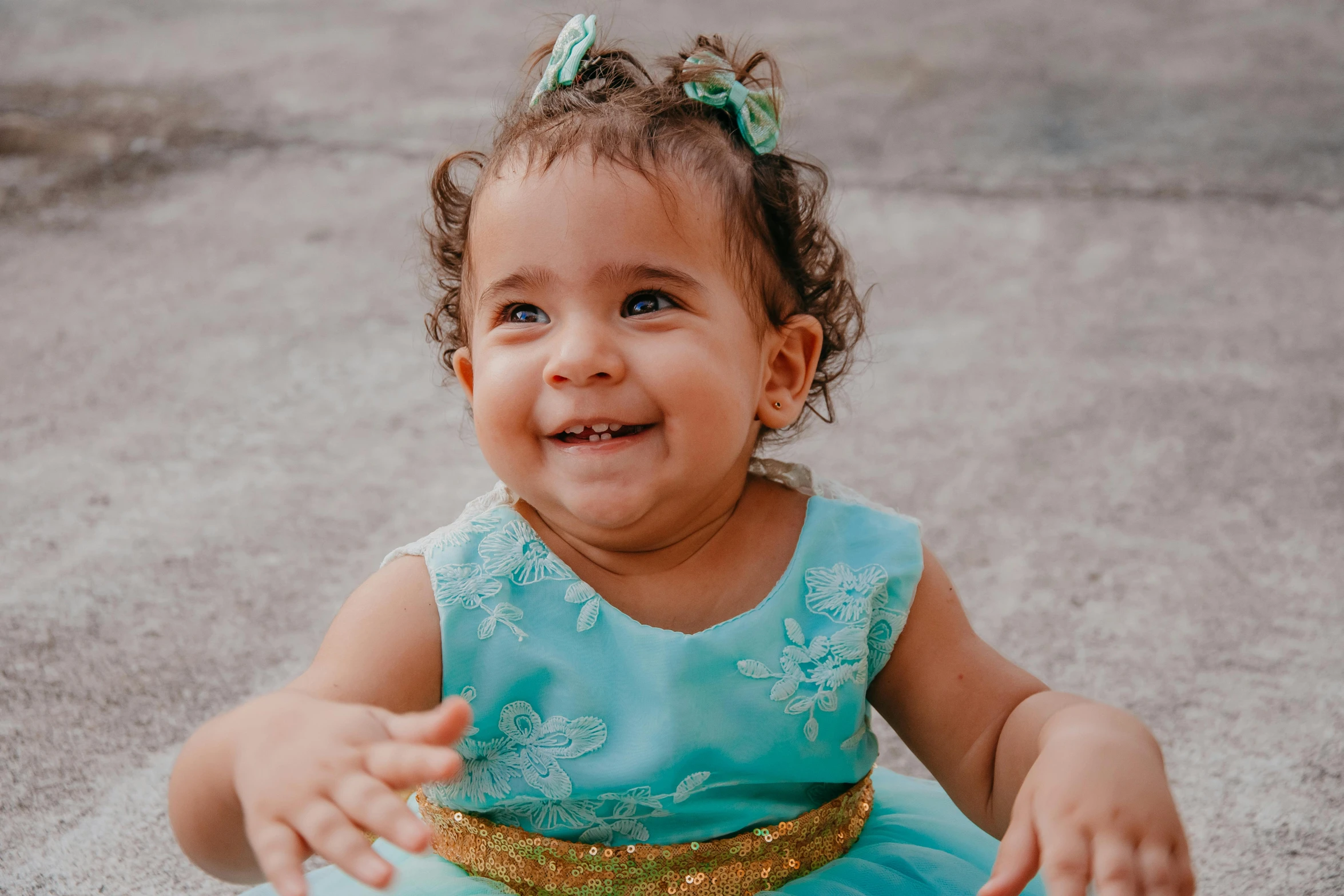 a little girl in a blue dress sitting on the ground, pexels contest winner, happening, mixed race, dimples, gif, toddler