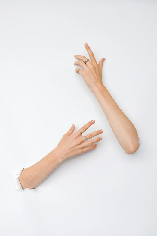 two hands reaching towards each other on a white surface, an album cover, inspired by Cornelia Parker, unsplash, visual art, skinny upper arms, ignant, 15081959 21121991 01012000 4k, asymmetry