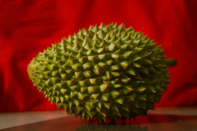 a close up of a fruit on a table, hurufiyya, wearing spiky, striking pose, no cropping, bao pnan