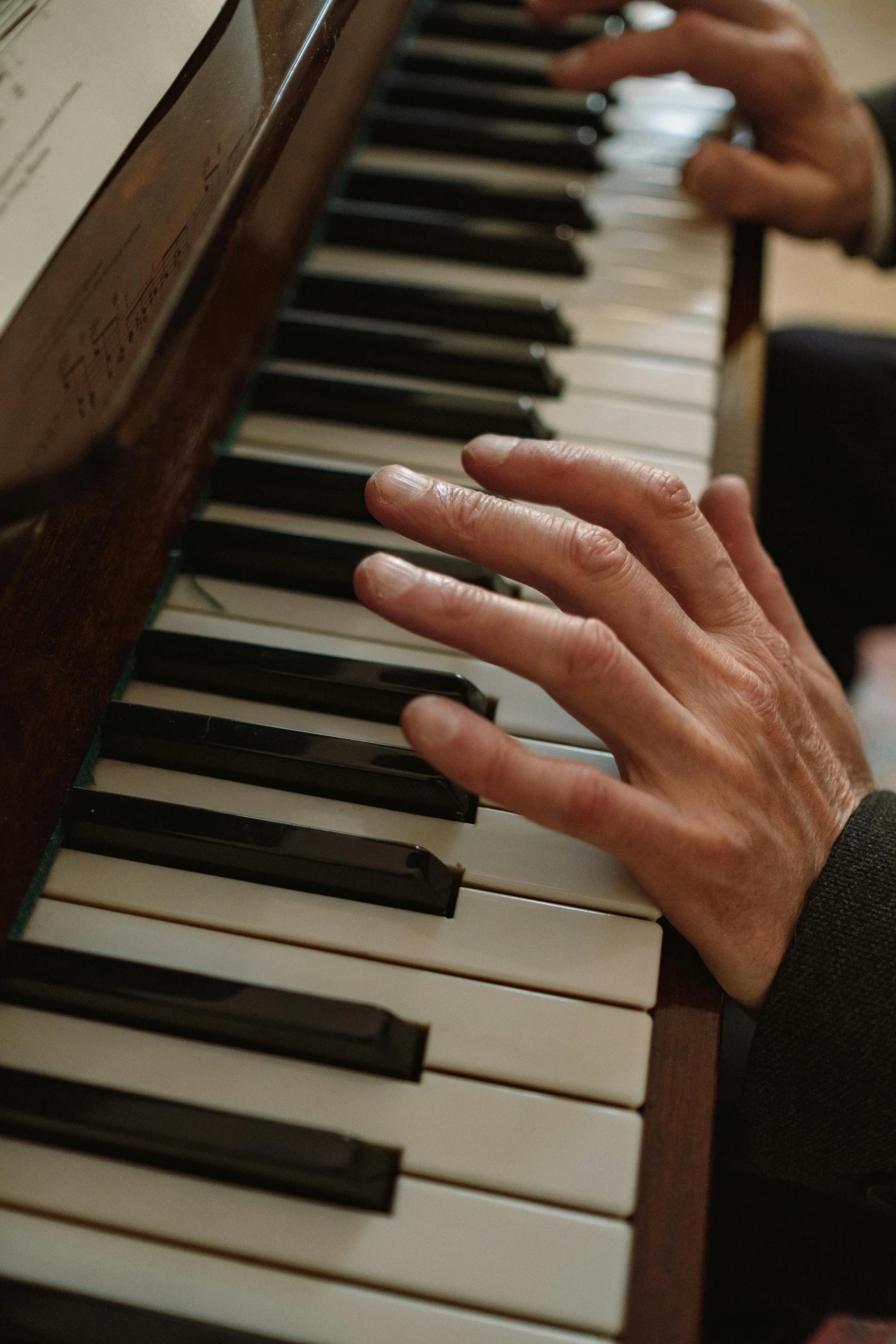 a close up of a person playing a piano, by Leo Michelson, paul barson, take my hand, corinne day, promo image