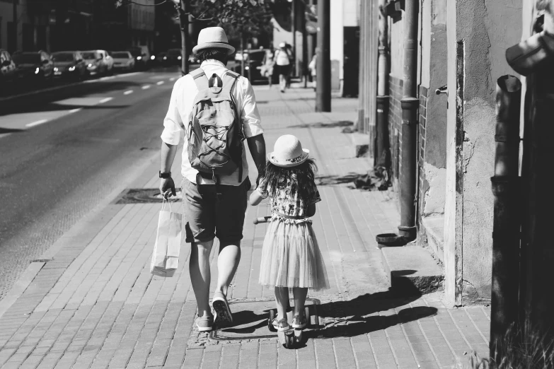 a man and a little girl walking down the street, a black and white photo, pexels, the man have a backpack, 🌸 🌼 💮, father figure image, fashionable