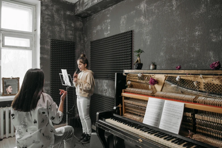 a woman standing next to a piano in a room, trending on pexels, studio ghibi, musicians playing instruments, 15081959 21121991 01012000 4k, commercial