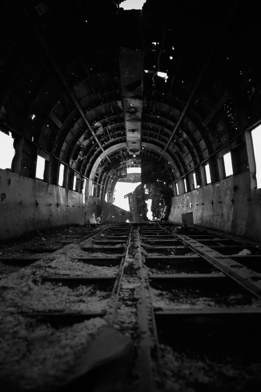 a black and white photo of a train tunnel, inspired by Bruce Davidson, surrealism, standing in a space ship wreck, inside airplane, 33mm photo, in a desolate