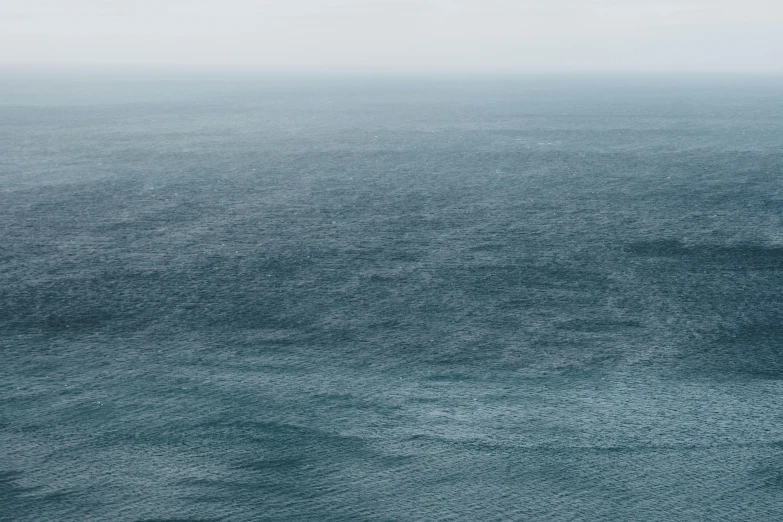 a person on a surfboard in the middle of the ocean, inspired by Andreas Gursky, unsplash contest winner, minimalism, blue gray, 2 5 6 x 2 5 6 pixels, foggy photo 8 k, ignant