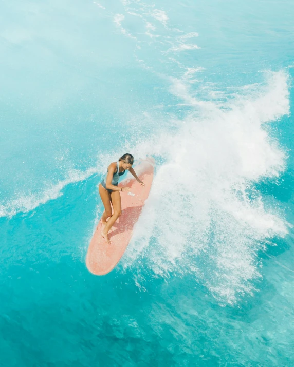 a woman riding a wave on top of a surfboard, pexels contest winner, pink white turquoise, slightly tanned, thumbnail, basia tran