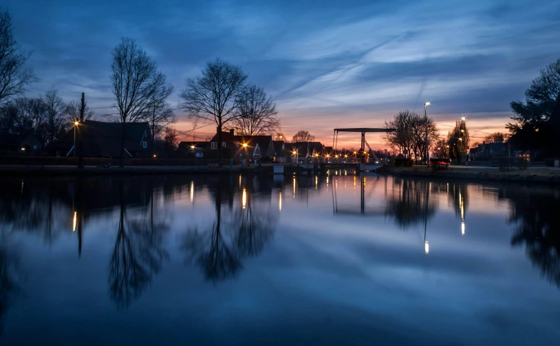 a large body of water surrounded by trees, a picture, by Jan Tengnagel, pexels contest winner, happening, peaceful evening harbor, delft, refracted sunset, thumbnail