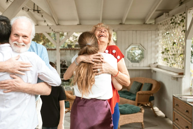 a couple of people that are hugging each other, by Carey Morris, pexels contest winner, happening, porches, celebration, happy family, background image