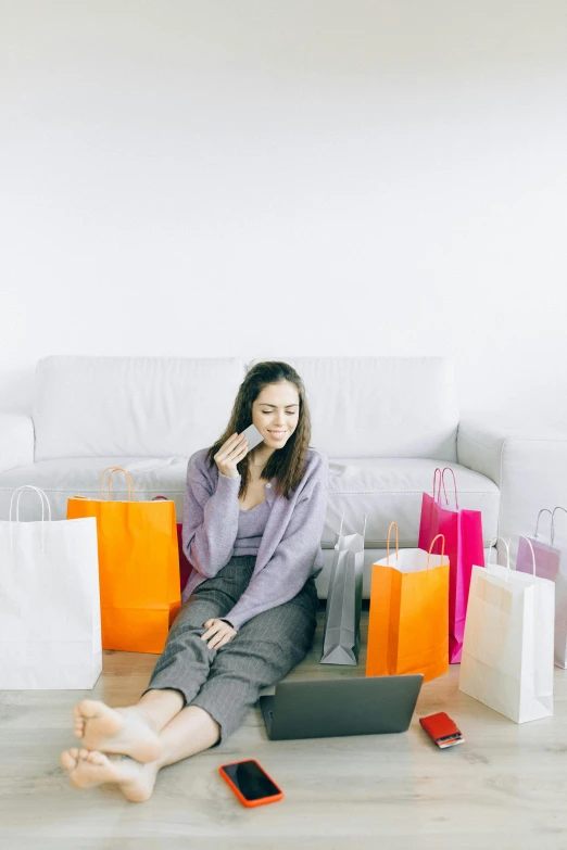 a woman sitting on the floor talking on a cell phone, retail price 4 5 0, curated collections, items and gadget, super