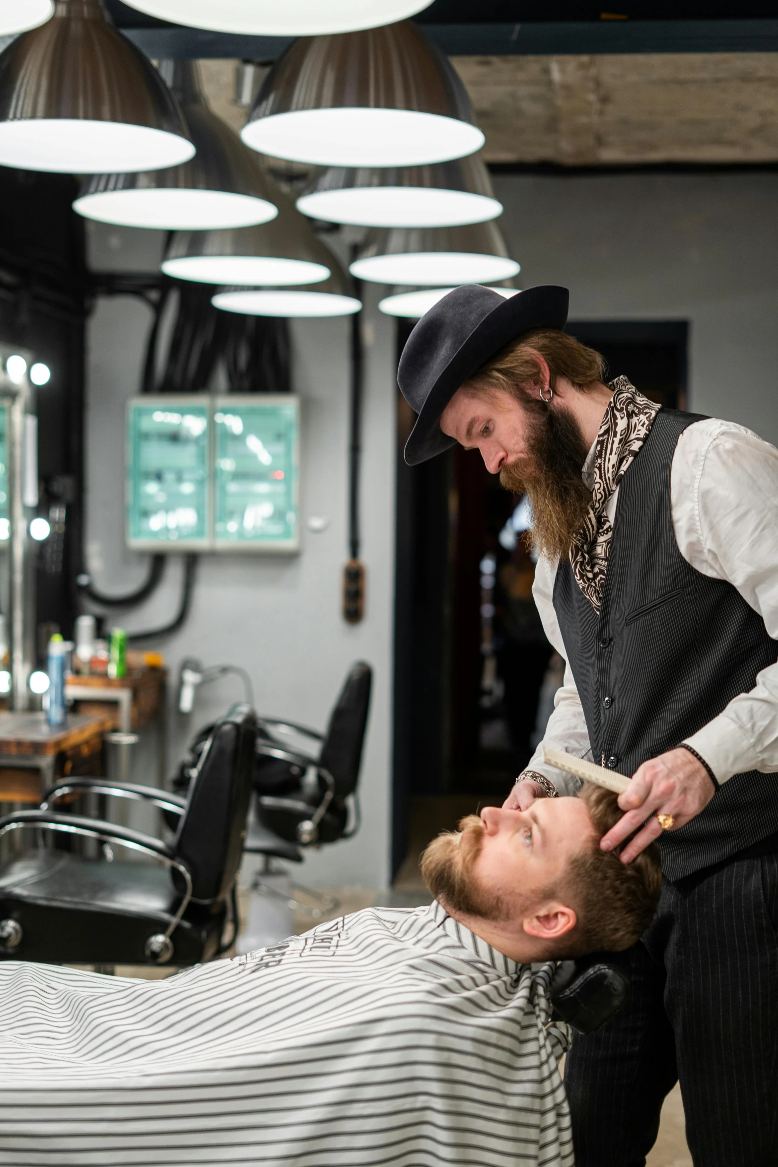 a man getting a haircut at a barber shop, by Julia Pishtar, waxed beard, production photo, thumbnail, lachlan bailey