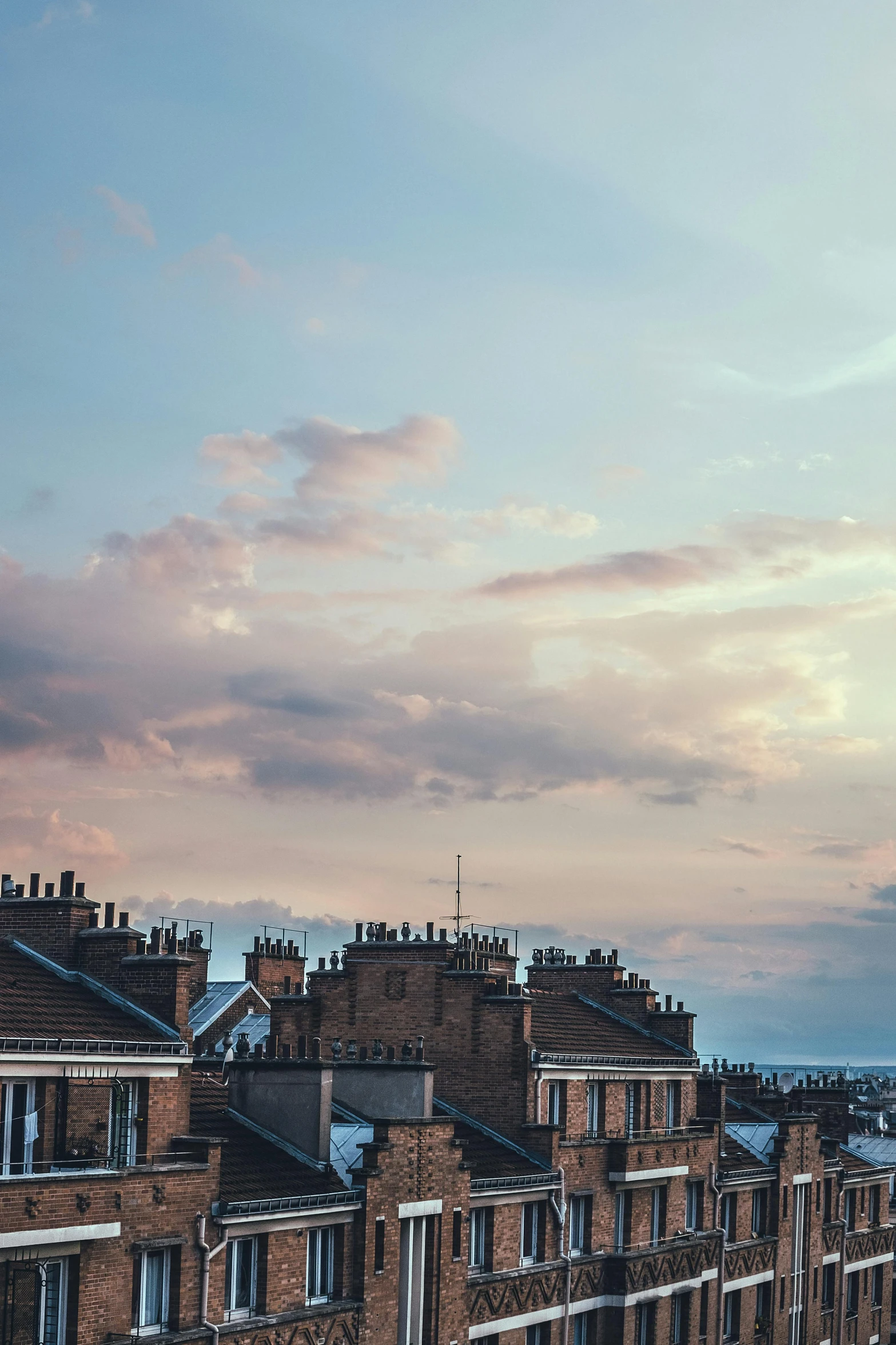 a very tall clock tower towering over a city, by Rachel Reckitt, pexels contest winner, chimneys on buildings, late summer evening, soft clouds, tall terrace