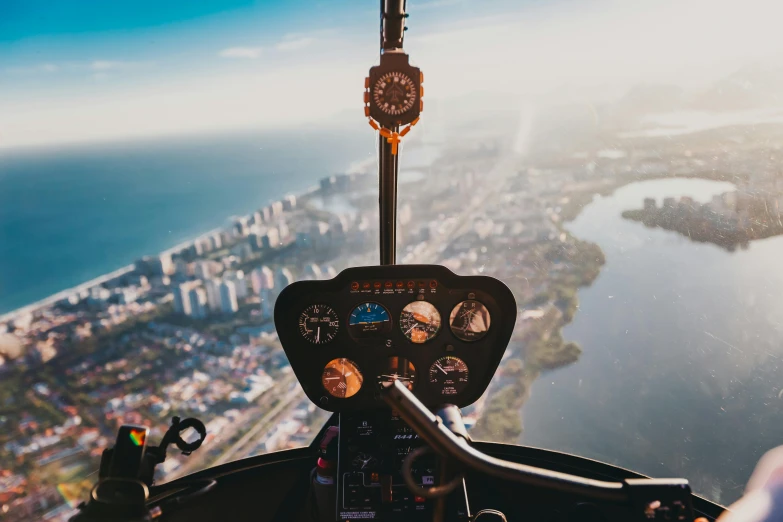 a view of a city from the cockpit of a helicopter, a photo, pexels contest winner, simple flight instruments, thumbnail, luxurious environment, looking onto the horizon