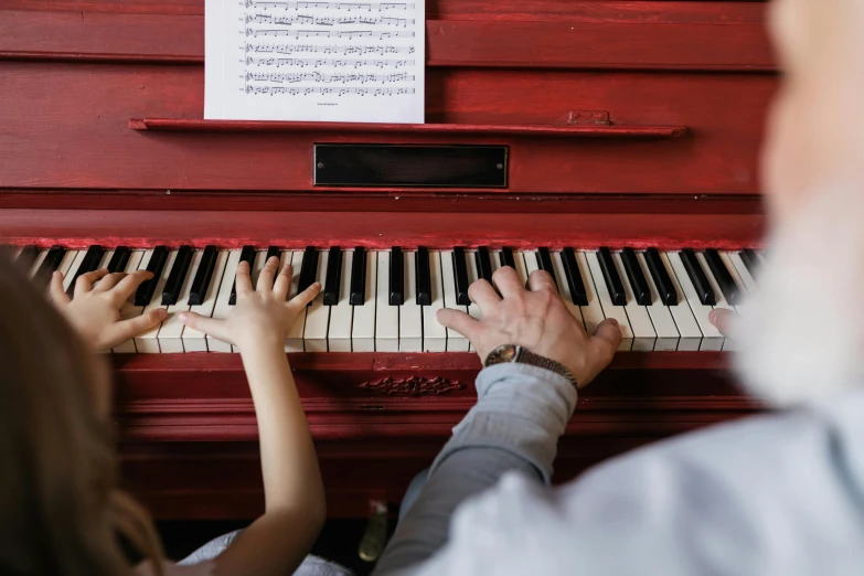 a man and a woman are playing the piano, by Arabella Rankin, pexels contest winner, white and red color scheme, school class, high quality photo, thumbnail
