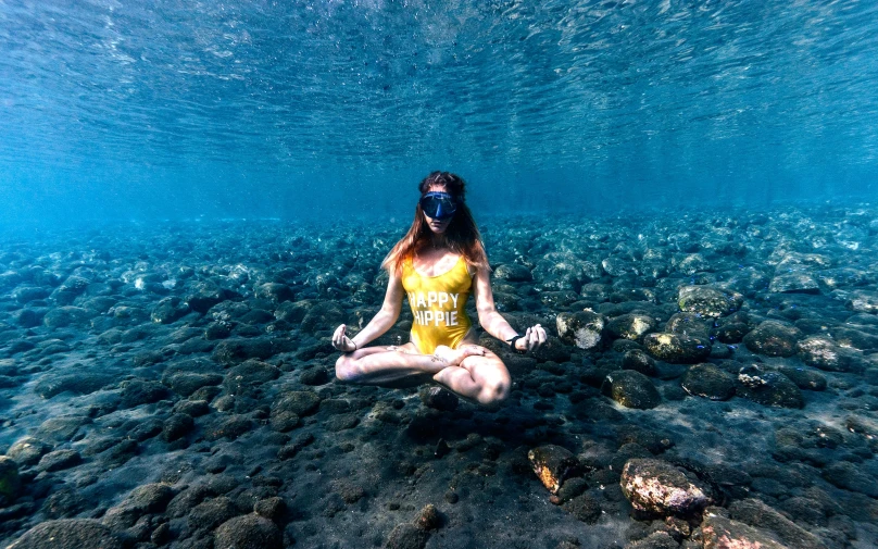 a woman sitting in the middle of a body of water, under the sea, yoga, bali, 🦩🪐🐞👩🏻🦳