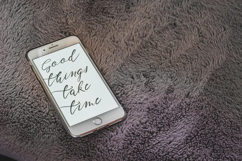 a cell phone sitting on top of a purple blanket, by Robbie Trevino, trending on pexels, tachisme, inspirational quote, chill time. good view, “modern calligraphy art, god like