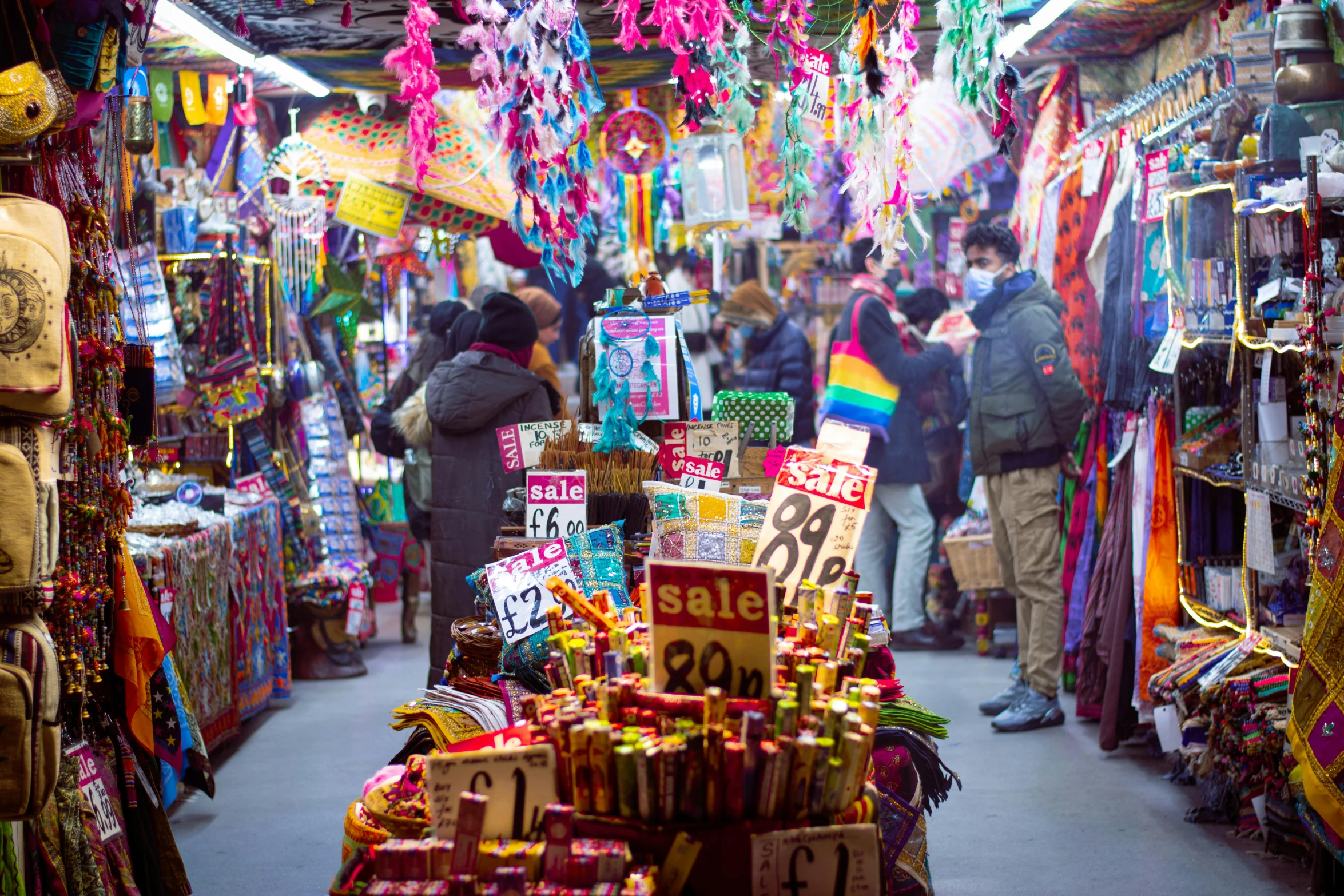 a store filled with lots of colorful items, trending on unsplash, street vendors, lit up, conde nast traveler photo, lgbtq