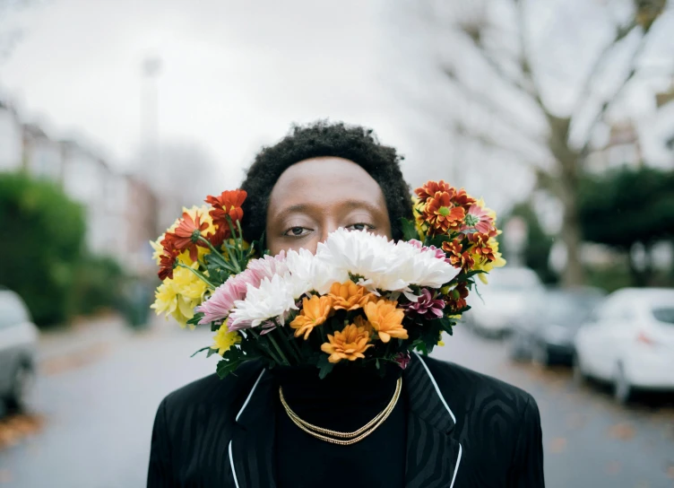 a woman with a bunch of flowers in her mouth, an album cover, pexels contest winner, black teenage boy, gentelman, flowercore, taken with sony alpha 9