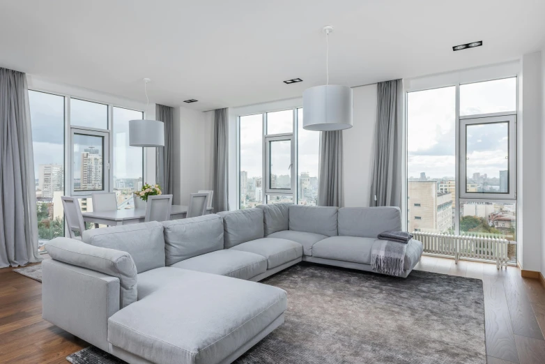 a living room filled with furniture and large windows, by Daniel Gelon, unsplash contest winner, light and space, grey and silver, white l shaped couch, penthouse, neo kyiv