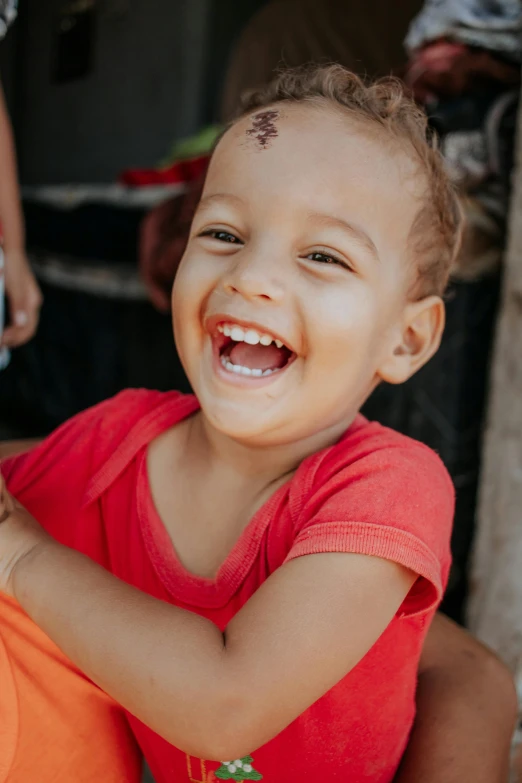 a close up of a person holding a child, happening, smiling face, bali, red cheeks, kids playing