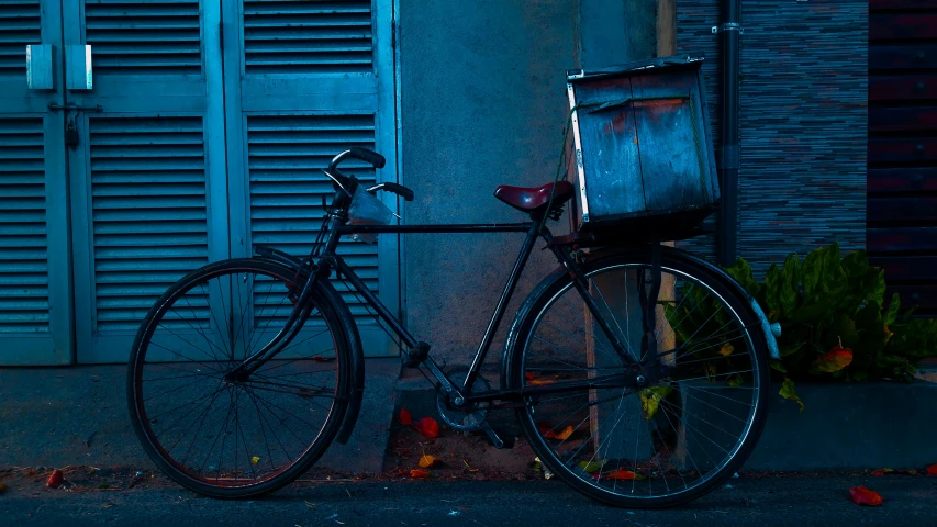 a bicycle parked in front of a blue building, an album cover, by Elsa Bleda, pexels contest winner, bill henson, new orleans, miscellaneous objects, lit from the side