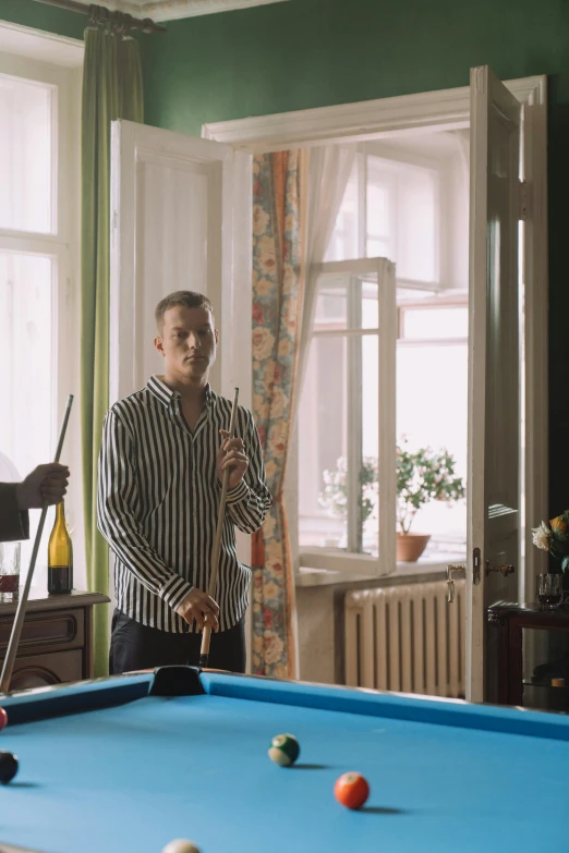 a couple of men standing next to a pool table, inspired by Tibor Czorba, still frame, **cinematic, alexander abdulov, home video