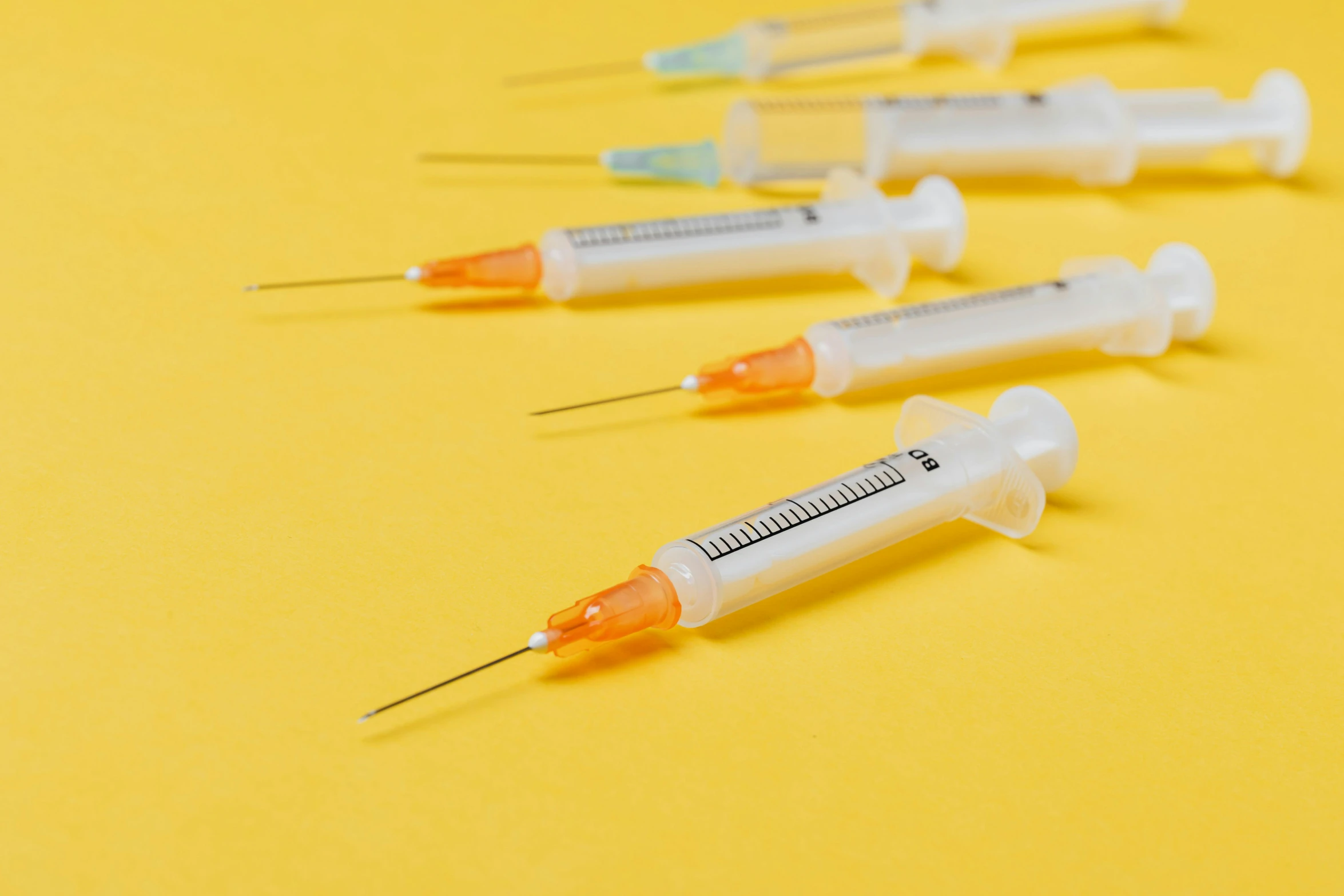 a row of sylls sitting on top of a yellow surface, by Rachel Reckitt, unsplash, holding syringe, ultra fine inklines, 4 0 0 0 samples, hexagonal shaped