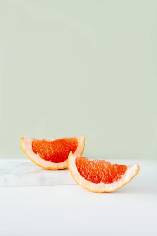 two grapefruits cut in half on a table, by Luma Rouge, smooth marble surfaces, carefully crafted, full profile, smooth tiny details