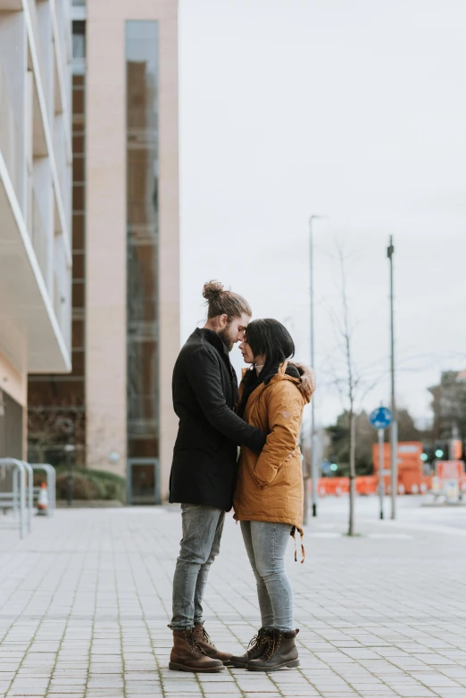 a man and woman kissing in front of a building, espoo, bruh moment, standing in a city center, 2 people