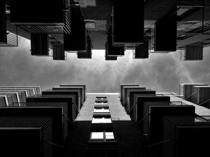 a black and white photo of a tall building, a black and white photo, by Tobias Stimmer, sky!!!, floating buildings, cinematic view from lower angle, mass housing