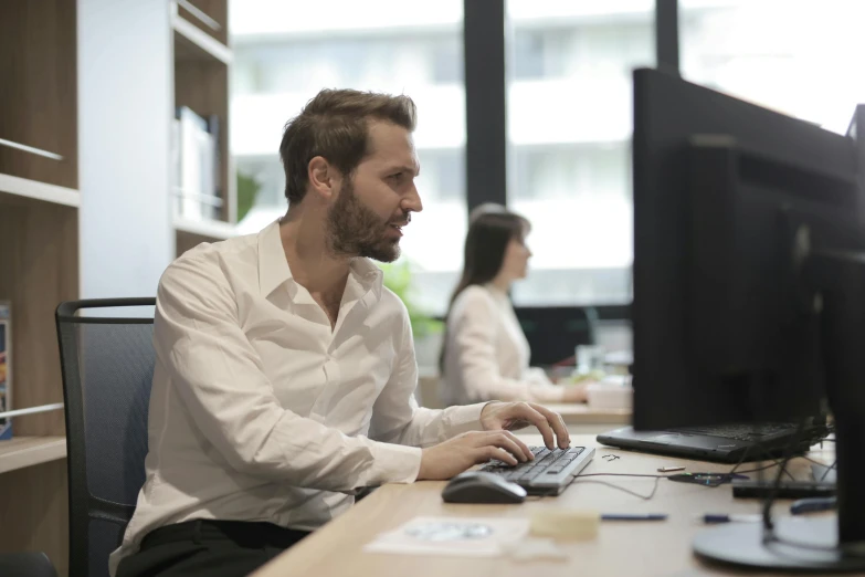 a man sitting at a desk using a computer, profile image, lachlan bailey, ash thorp khyzyl saleem, people at work