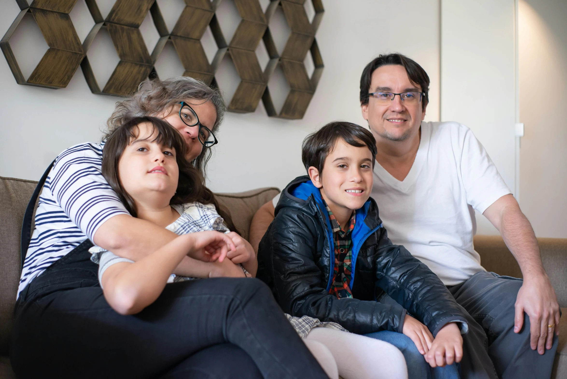 a group of people sitting on top of a couch, a portrait, by Carey Morris, pexels, husband wife and son, andy milonakis, avatar image, clean design