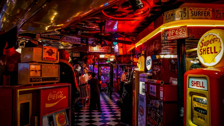 a couple of vending machines sitting next to each other, by Joe Bowler, pexels contest winner, maximalism, dive bar with a karaoke machine, red neon, 1 9 5 0's decor, a busy arcade