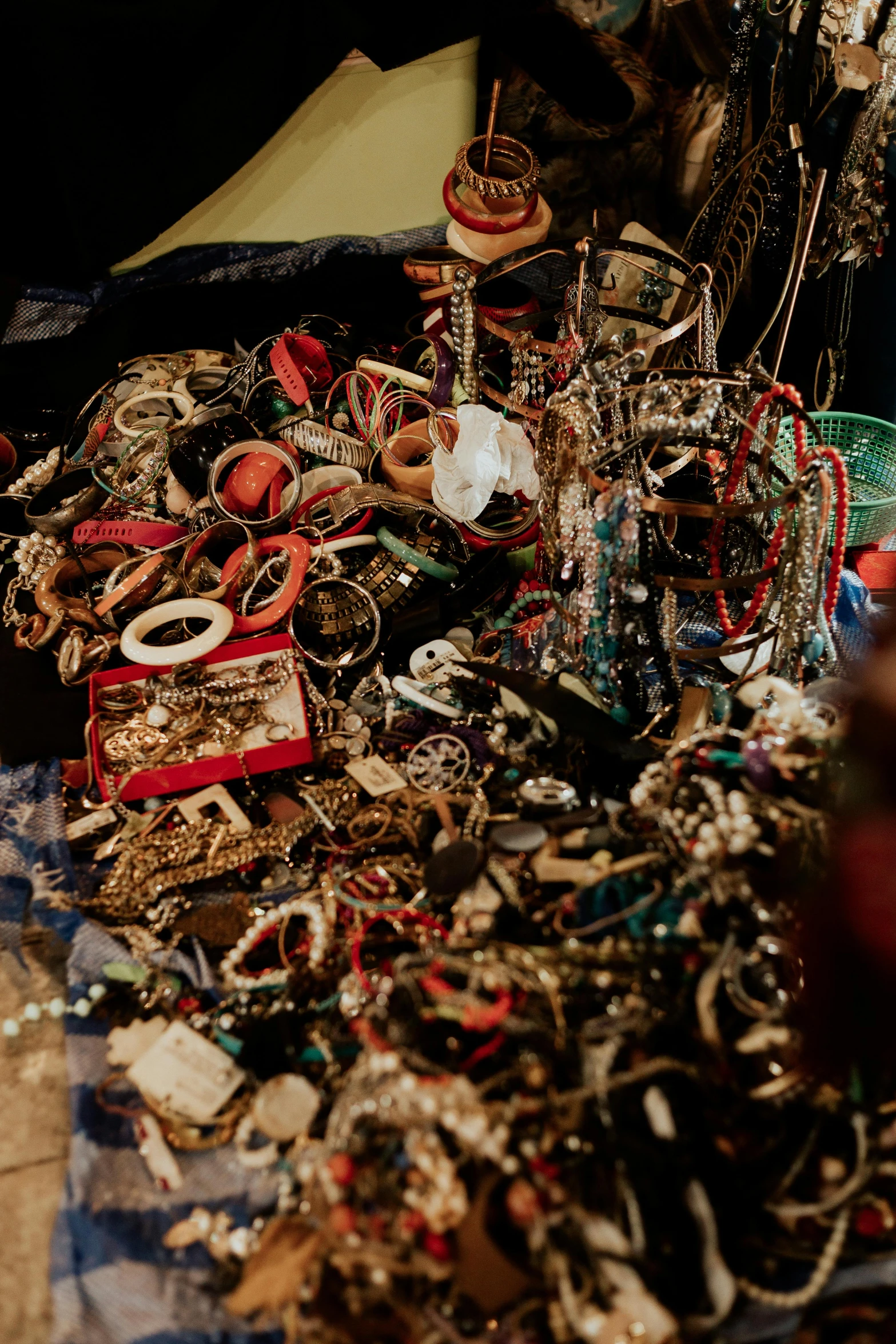 a pile of jewelry sitting on top of a table, an album cover, trending on unsplash, assemblage, inside an arabian market bazaar, panorama, junkyard, - 9