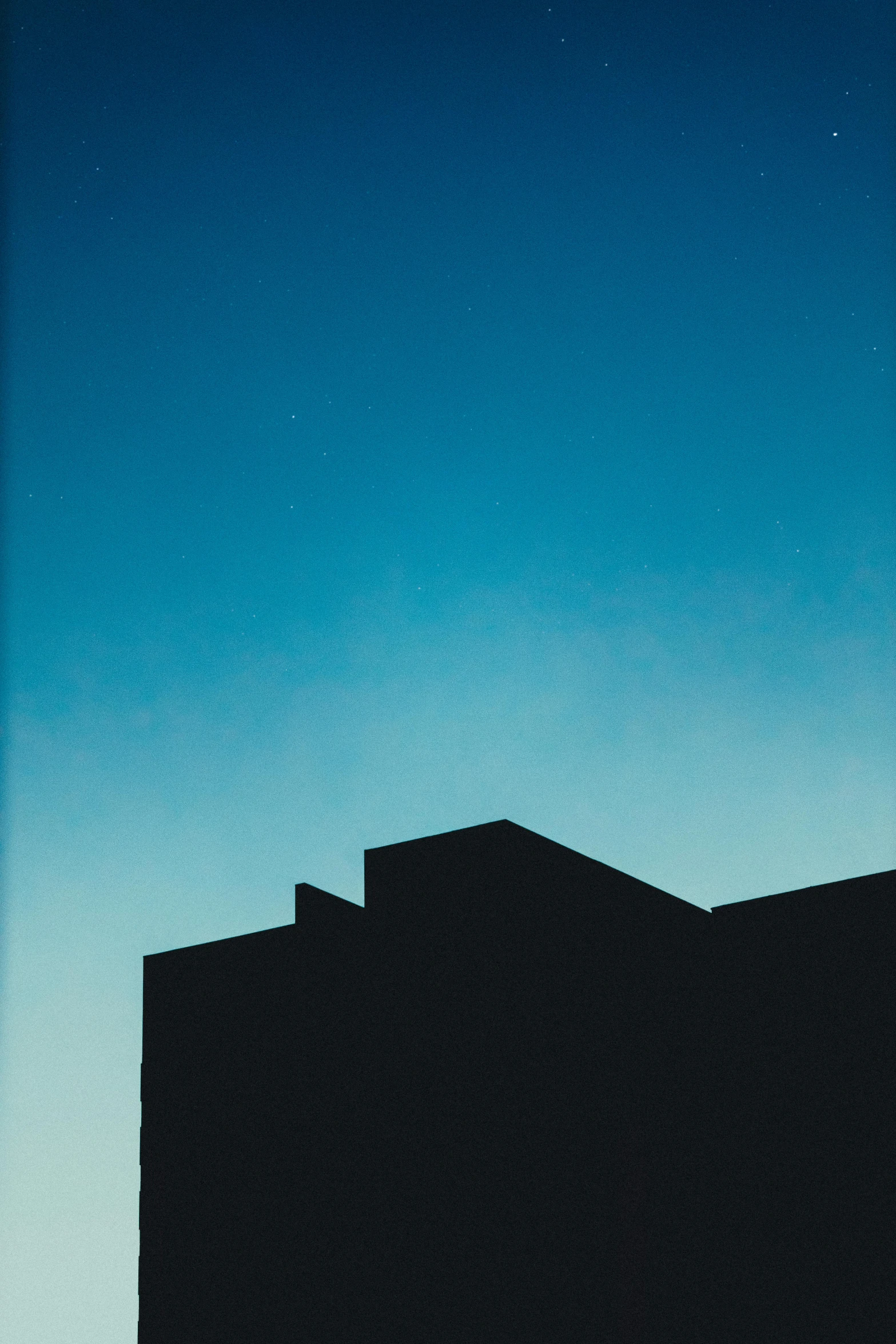 the silhouette of a building against a blue sky, by Russell Chatham, postminimalism, medium format. soft light, kano)