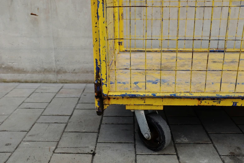 a yellow cart sitting on top of a sidewalk, by Andries Stock, unsplash, cages, pbr textures, 15081959 21121991 01012000 4k, full pallet image