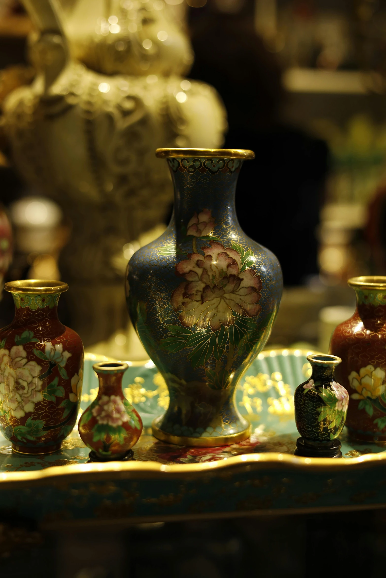 a group of vases sitting on top of a tray, flickr, cloisonnism, heavily detailed and intricate, smooth tiny details, gold inlay, at night