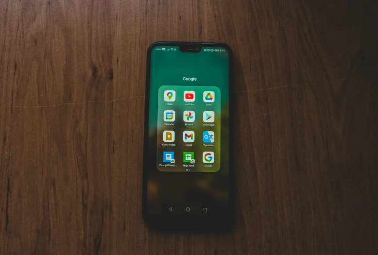 a cell phone sitting on top of a wooden table, by Android Jones, trending on pexels, realism, green and brown clothes, vertical wallpaper, clear glass wall, with lots of text and icons