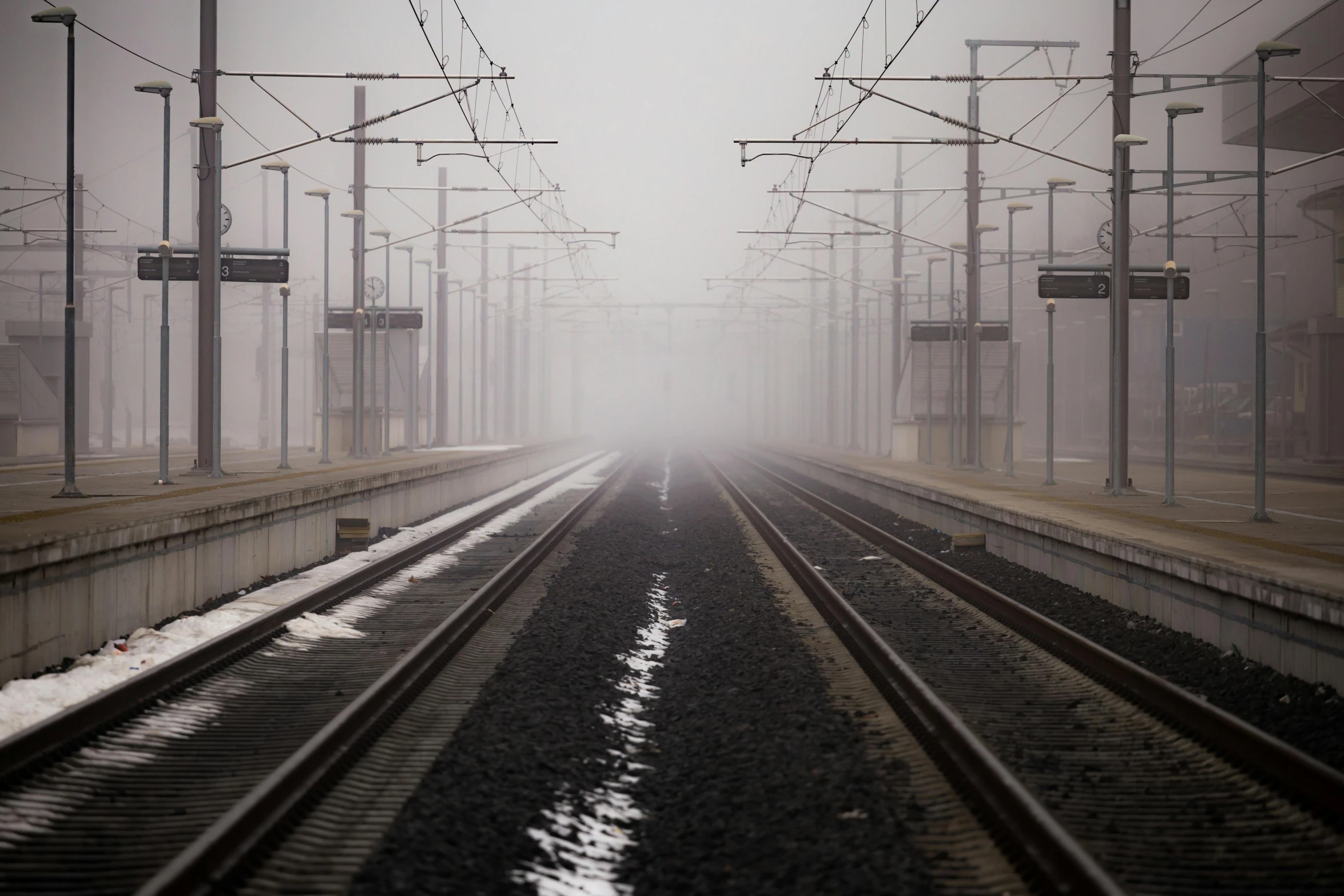 a train station on a foggy day, pexels contest winner, railway tracks going through it, low visibility, tgv, barely visible