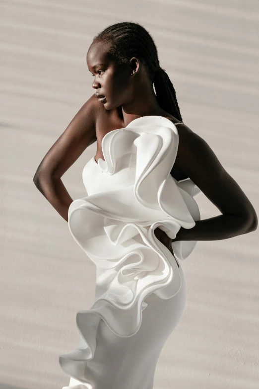 a woman in a white dress posing for a picture, inspired by Antonio Rotta, trending on pexels, made of silk paper, adut akech, ruffles, sleek curves