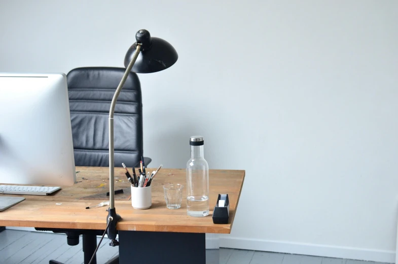 a desktop computer sitting on top of a wooden desk, by Andries Stock, postminimalism, one single gas lamp, studio harcourt, with clear glass, office furniture