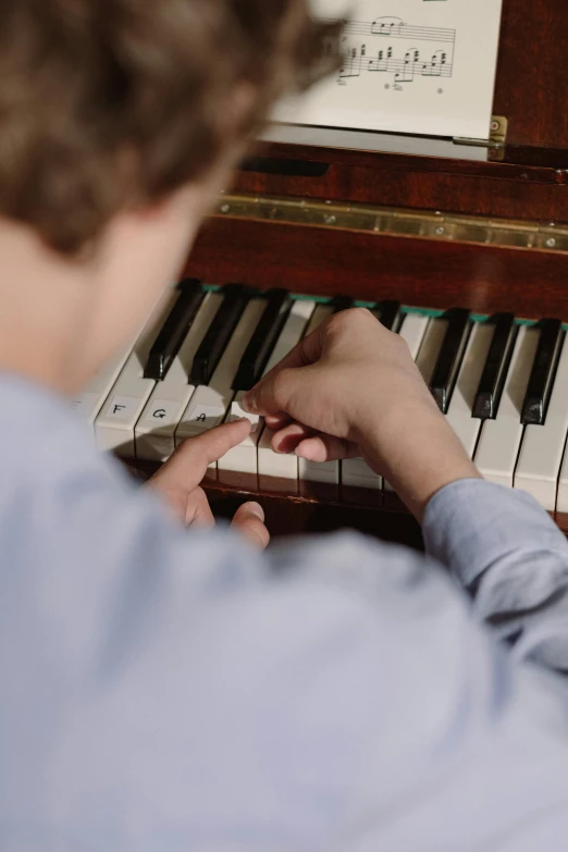 a close up of a person playing a piano, private school, paul barson, lachlan bailey, small in size
