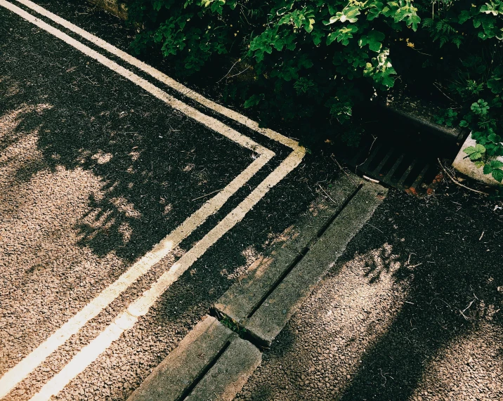 a red fire hydrant sitting on the side of a road, an album cover, unsplash, postminimalism, hedges, tyre mark, shady alleys, 1980s photo