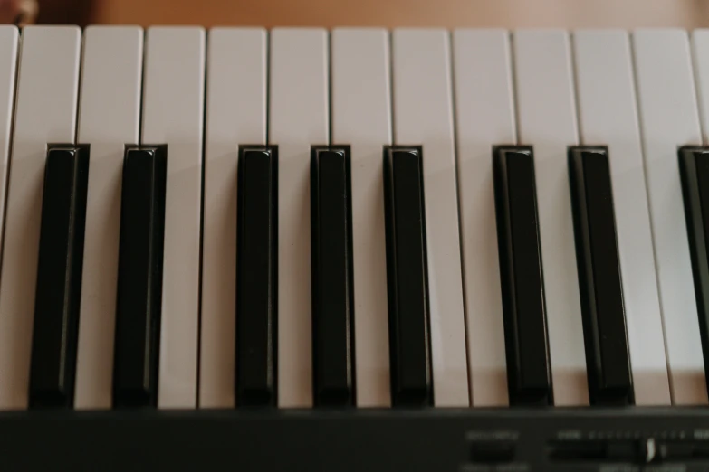 a close up of the keys of a piano, by Romain brook, trending on pexels, on a pale background, electronic, upright, shot on canon eos r5