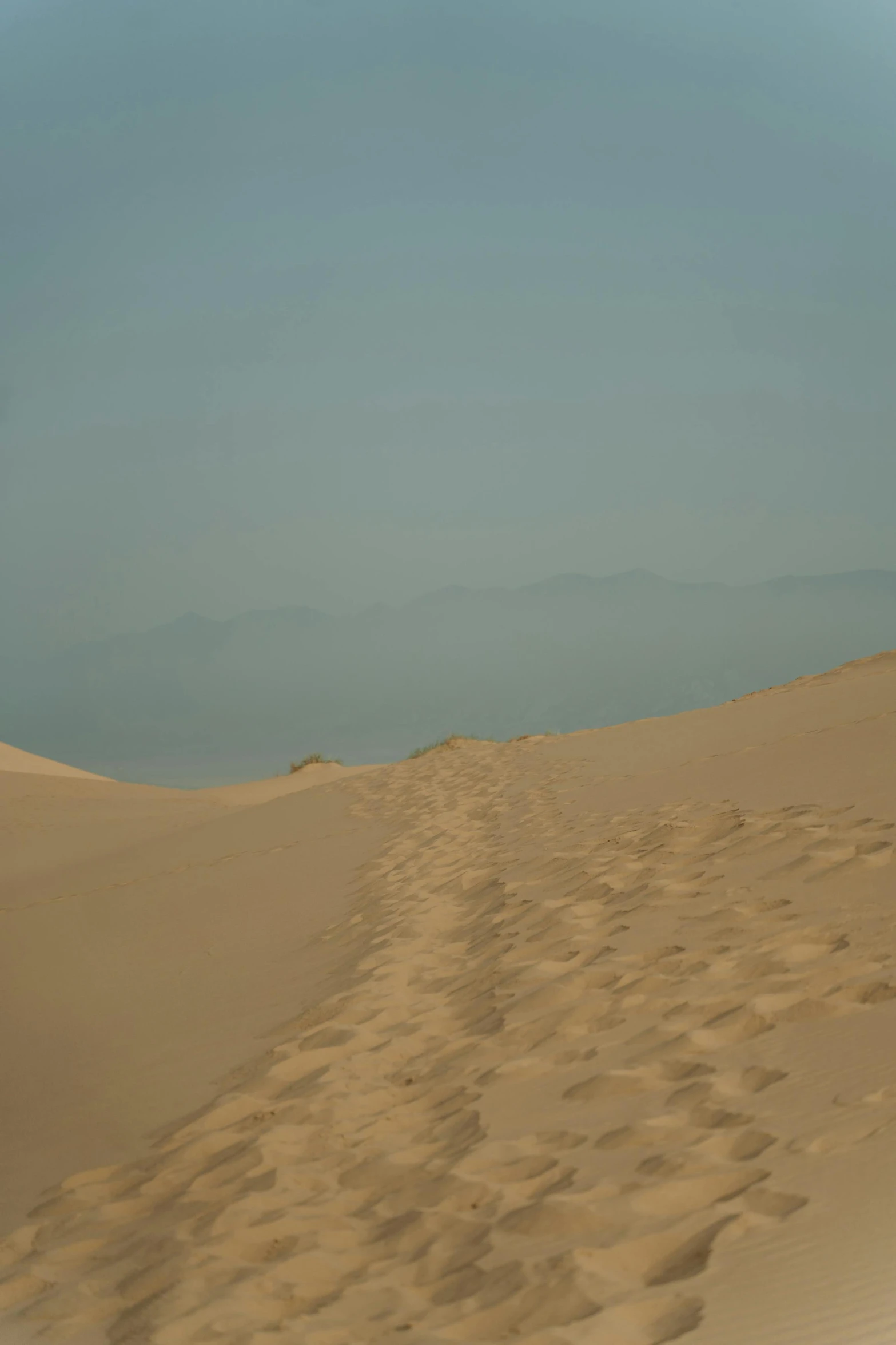 a man riding a surfboard on top of a sandy beach, a picture, inspired by Zhang Kechun, flickr, mingei, walking over sand dunes, 2 5 6 x 2 5 6 pixels, desert highway, an ancient path