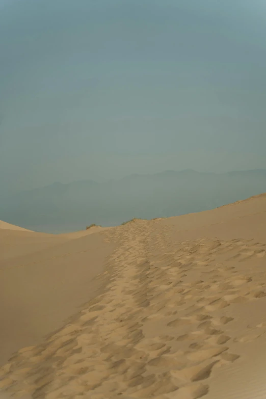 a man riding a surfboard on top of a sandy beach, a picture, inspired by Zhang Kechun, flickr, mingei, walking over sand dunes, 2 5 6 x 2 5 6 pixels, desert highway, an ancient path