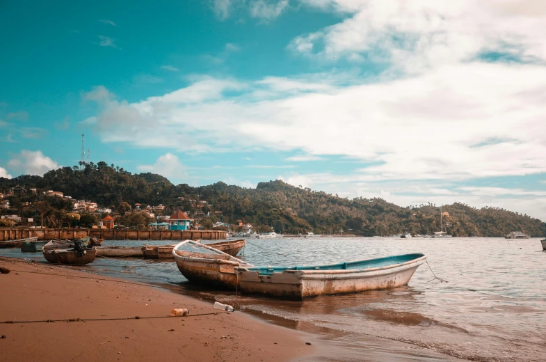 a boat sitting on top of a beach next to a body of water, a photo, fishing village, múseca illil, avatar image